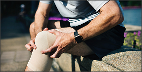 Man sitting on a bench with knee pain